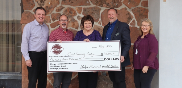 PMHC representatives and CCC representatives stand with a big check for grant donation