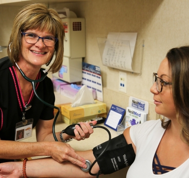 Nurse taking patients blood pressure
