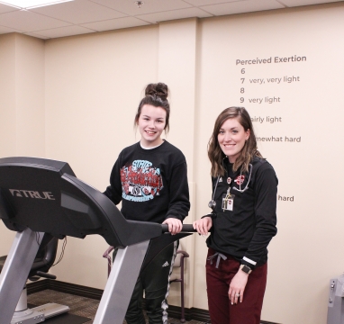 Patient on treadmill with exercise physiologist Laramey Becker