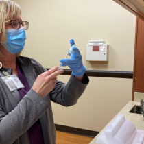 nurse drawing up COVID vaccine